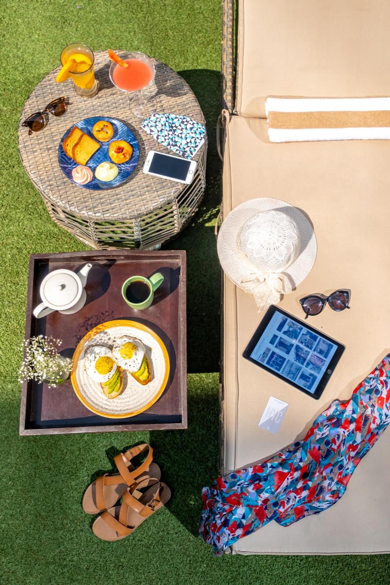 Hyatt Centric Candolim Goa Kültér fotó A woman using a tablet computer